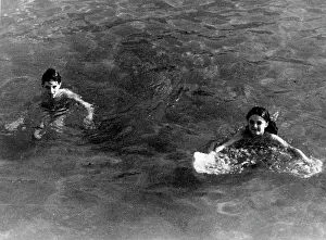 Siblings: Brother and sister swimming