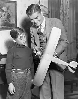 Teenaged: Brothers with model airplane