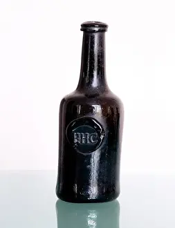 Receptacles: Brown glass wine bottle marked HHC
