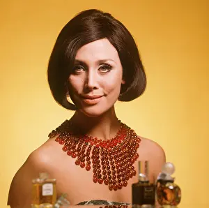 Coiffured: Brunette model wearing large beaded necklace