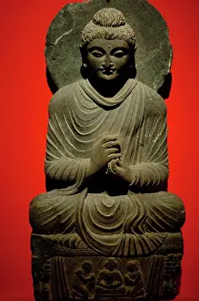 Pleats: Buddha statue with dharmachakra mudra gesture. 2nd-3rd centu