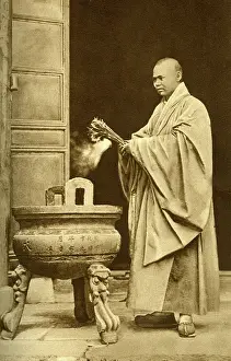 Devout: Buddhist priest holding joss sticks, China, East Asia