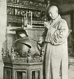 Gong: Buddhist priest striking a temple bell, China, East Asia