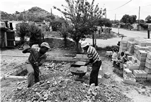 Plastering: Builders at work in Oukasie Township, Brits. North