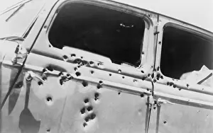 Riddled: The bullet riddled car in which bank robbers ?