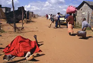 Squatter: The burned body of a man lies covered by a red