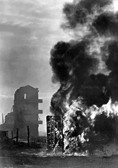 Retreating: Burning building of a former airfield in Roslaw