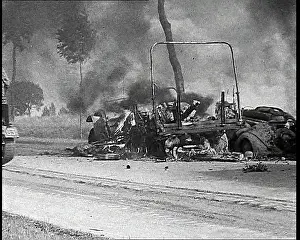 Burning and Wrecked Vehicles on the Side Of