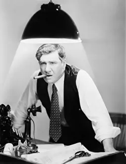 Intent: Businessman with cigar under lamp