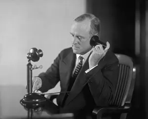 Dialing: Businessman dialing an early 20th century ?