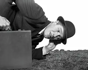 Businesspeople: Businessman with one ear to the ground holding