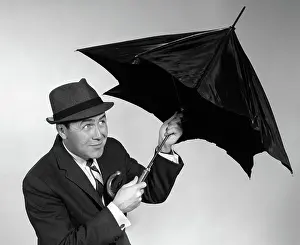 Businesspeople: Businessman opening up umbrella