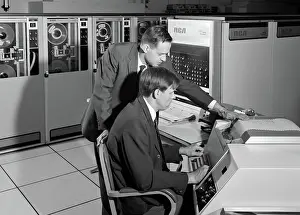 Businesspeople: Two businessman programming large mainframe computer
