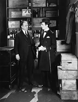 Bowlers: Businessmen conversing in storeroom