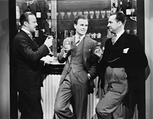 Calendars: Businessmen drinking together at bar