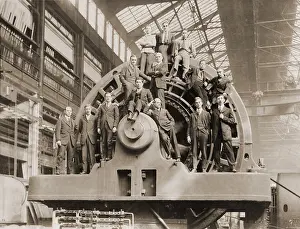 Generators: Businessmen pose on a giant Westinghouse ?