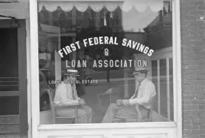 Storefront: Two businessmen sit behind the storefront ?