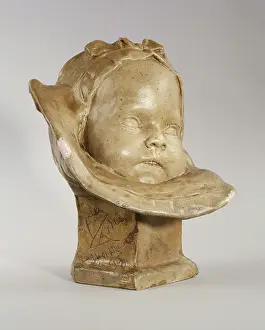 Stoneware: Bust of a baby with bonnet and bib