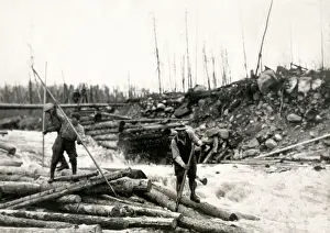Logs: c.1920's logging in Canada, men guiding logs down a river