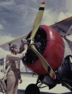Cadet: Cadet checking the propeller on a plane at