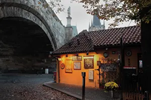 Strana: Cafe Marnice under an arch of the Charles Bridge