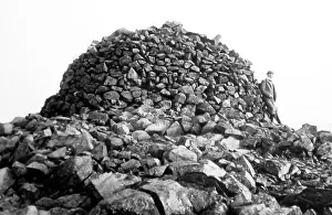 Climber: Cairn at the summit of Scafell Pike, Lake District