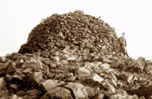 Climber: Cairn at the summit of Scafell Pike, Lake District