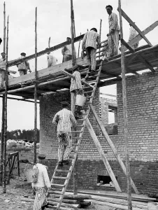 Prewar: Camp internees in striped uniforms doing forced labour at Sa