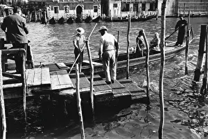 Gondoliers: Canal in Venice with a gondola