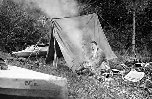 Campers: A canoeist on a trip has set up his tent camp and