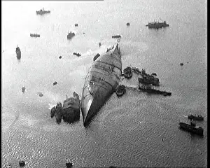 Capsized: A Capsized Italian Ship At Sea Being Approached