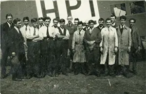 Capt: Capt G.T.R. Hill (centre) with a group of mechanics in f