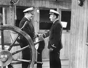 Respectable: Two captains shaking hands on a boat
