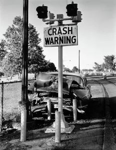 Aching: Car crashed head-on into crash warning sign pole