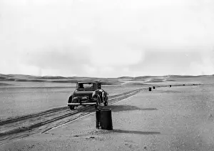 Permission: A car drives on a road marked by barrels through