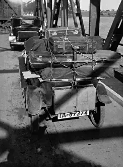 Dixi: Car packed with suitcases on a bridge, 1931