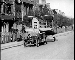 Towing: A Car Towing a Small Aeroplane With Its Wings