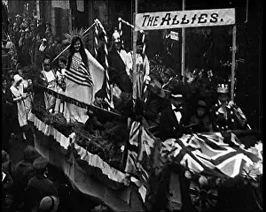 British Pathé Ltd: Carnival Procession Passing By A Crowd. There