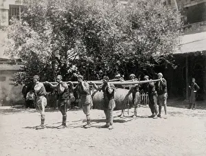 Porters: Carrying a wine or water barrel, Constantinople, Istanbul, T