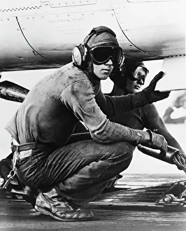 Catapult: Catapult crewmen hook up the launch cable