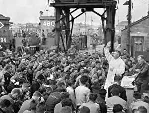 Lcgr1402: Catholic chaplain conducts services on a pier