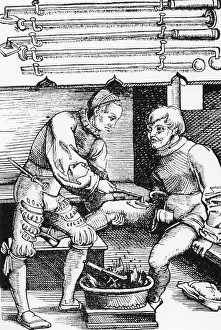 Illustrates: Cauterizing of a wound, 1528