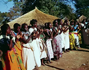 Rondavels: Central eastern Zimbabwe. Washing the camel and child