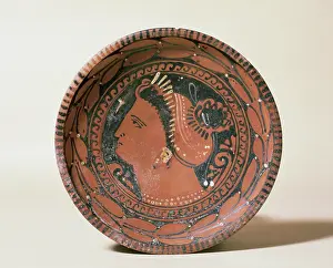 Shallow: Ceramic plate. Decorated head matron. Greek imitation. 3rd c