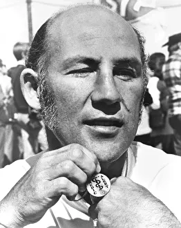 15062: Champion racing driver Sterling Moss promoting