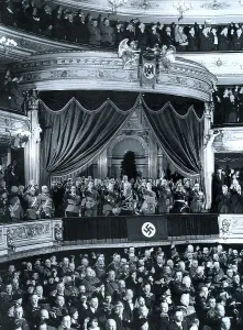 Attending: Chancellor Adolf Hitler is greeted by an audience