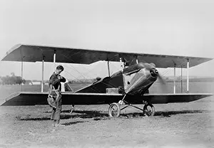 Bi Plane: Charles Lindbergh, adjusting parachute before testing