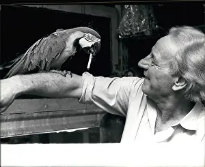 Decides: Charlie the macaw with cigarette and owner Ray Mayer