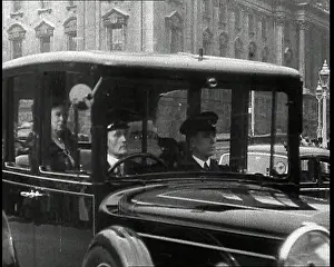 Teck: A Chauffeur is Driving a Car Containing Queen