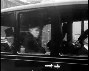 Teck: A Chauffeur is Driving a Car Containing Queen